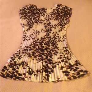 This beautiful silky top has never been worn.